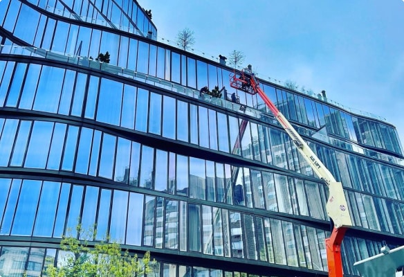 Top Team commercial window cleaning on aerial lift