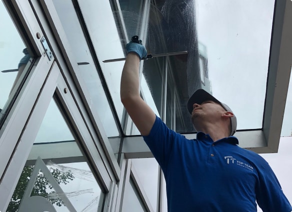 Top Team window cleaning glass canopy post-construction